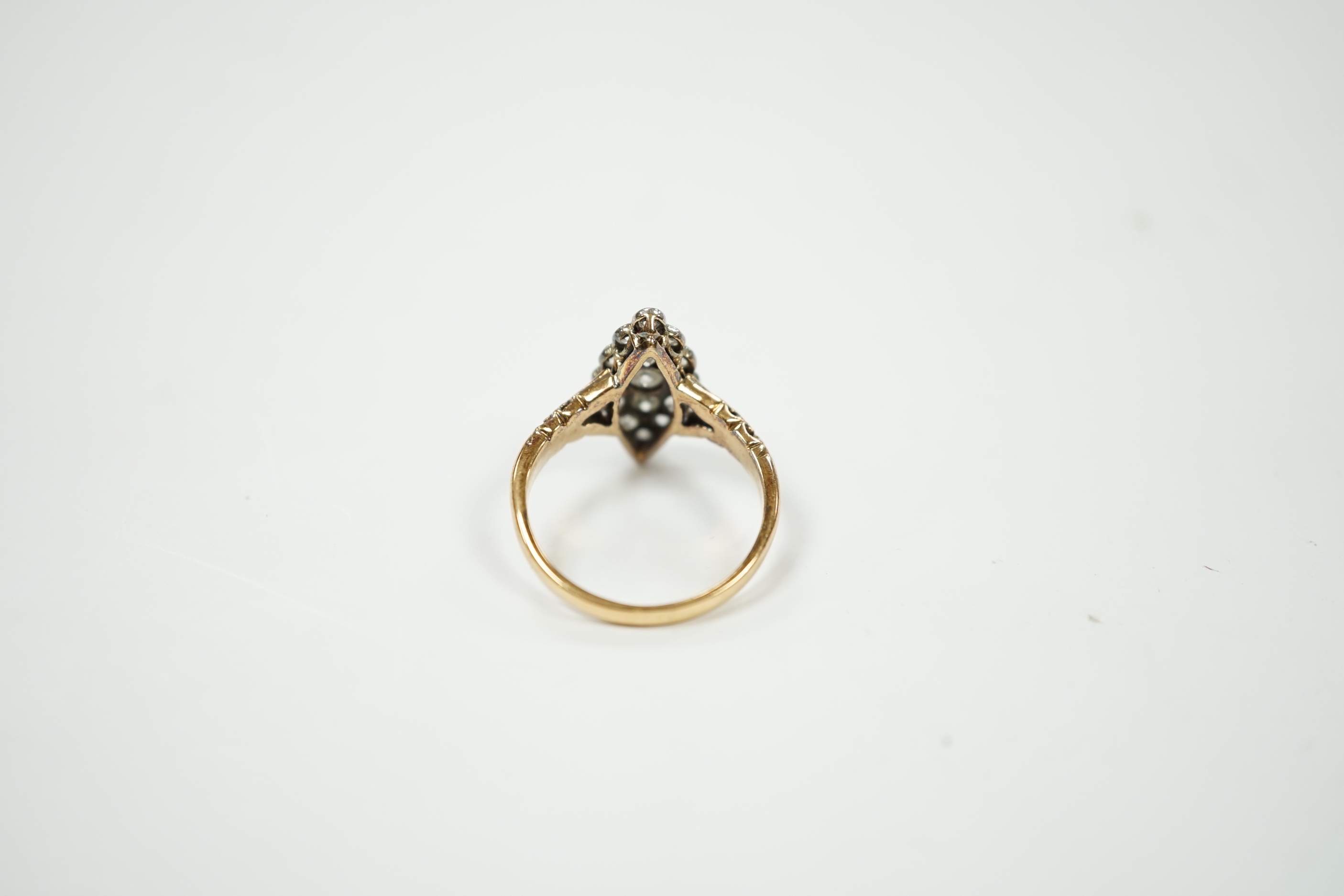 An 18ct and diamond set marquise cluster shaped ring, size N/O, gross weight 4 grams.